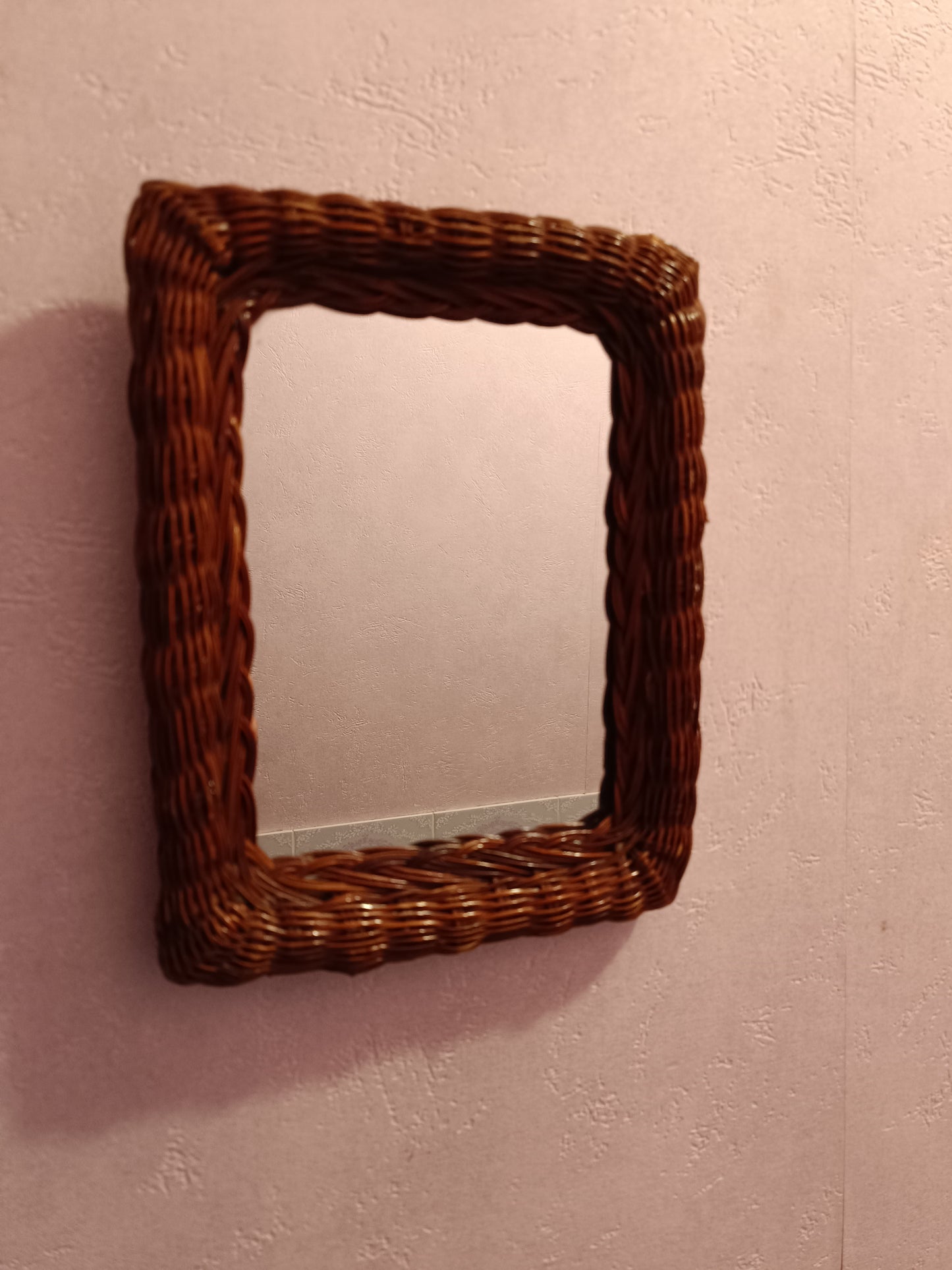 Miroir en rotin teinté et tressé.