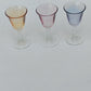 Lot de six verres à liqueur ou digestif de différentes couleurs.